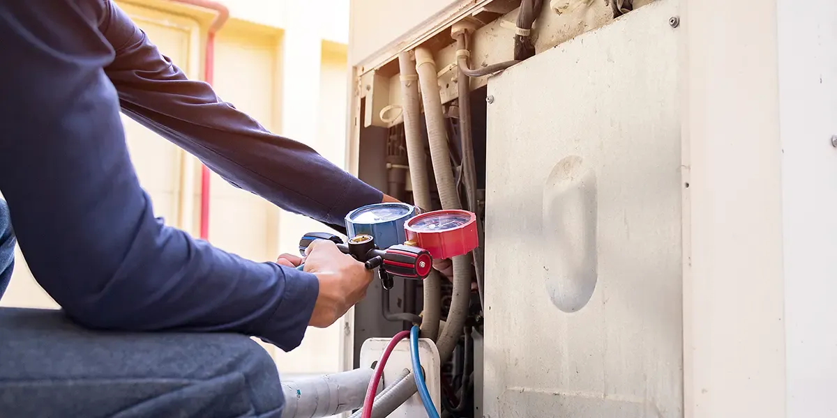 An HVAC Technician check the refrigerant on an HVAC system