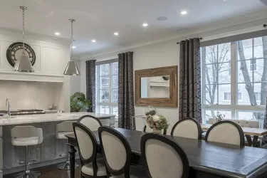 A dining room with recessed lighting overhead