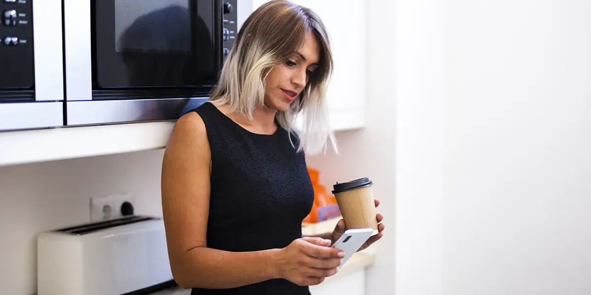 A woman on her phone looking for replacement appliances